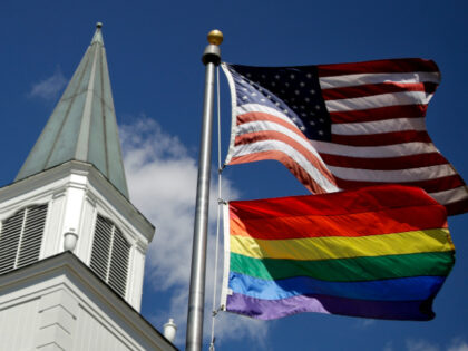 In this April 19, 2019 file photo, a gay pride rainbow flag flies along with the U.S. flag in front of the Asbury United Methodist Church in Prairie Village, Kan. Conservative leaders within the United Methodist Church unveiled plans Monday, March 1, 2021 to form a new denomination, the Global …
