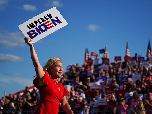PERRY, GA - SEPTEMBER 25: Rep. Marjorie Taylor Greene (R-GA) holds a sign that reads Impeach Biden at a rally featuring former US President Donald Trump on September 25, 2021 in Perry, Georgia. Republican Senate candidate Herschel Walker, Georgia Secretary of State candidate Rep. Jody Hice (R-GA), and Georgia Lieutenant …