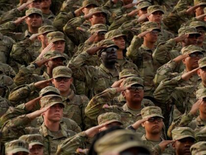 Members of the U.S. Military salute during a ceremony to redesignate Fort Benning as Fort