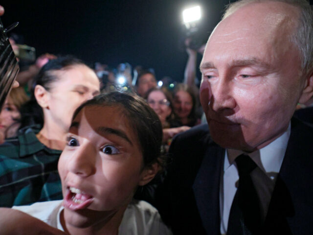 Russian President Vladimir Putin, right, meets with local citizens during his working visi