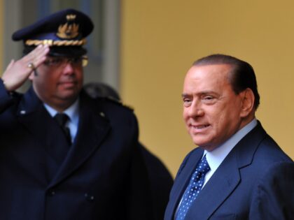 Italian Prime Minister Silvio Berlusconi walks during a meeting with Vietnamese President