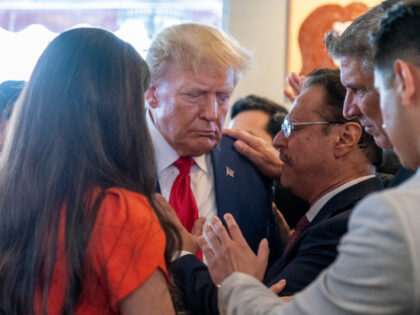 Former President Donald Trump prays with pastor Mario Bramnick, third from right, and others at Versailles restaurant on Tuesday, June 13, 2023, in Miami. Trump appeared in federal court Tuesday on dozens of felony charges accusing him of illegally hoarding classified documents and thwarting the Justice Department's efforts to get …