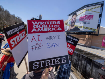 LOS ANGELES, CA - MAY 02: People picket outside of FOX Studios on the first day of the Hollywood writers strike on May 2, 2023 in Los Angeles. Scripted TV series, late-night talk shows, film and streaming productions are being interrupted by the Writers Guild of America (WGA) strike. In …