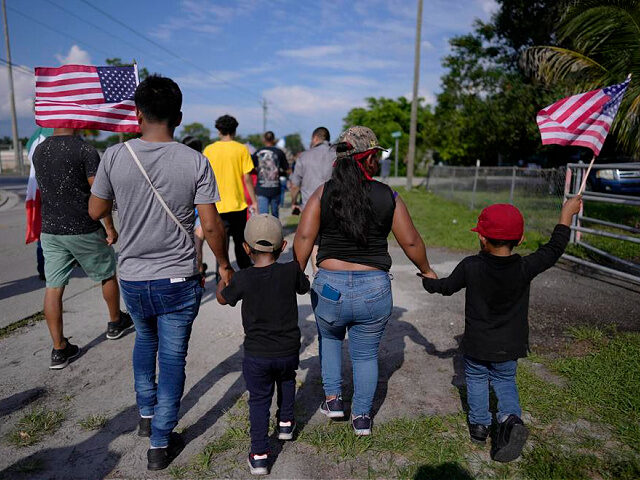 Members of the Aguilar family, whose older members immigrated from Guatemala, carry American flags as they march along with hundreds of others during a peaceful protest against Florida Senate bill 1718, which imposes restrictions on undocumented immigrants, Thursday, June 1, 2023, in Immokalee, Fla., an area known for its tomato-growing. …