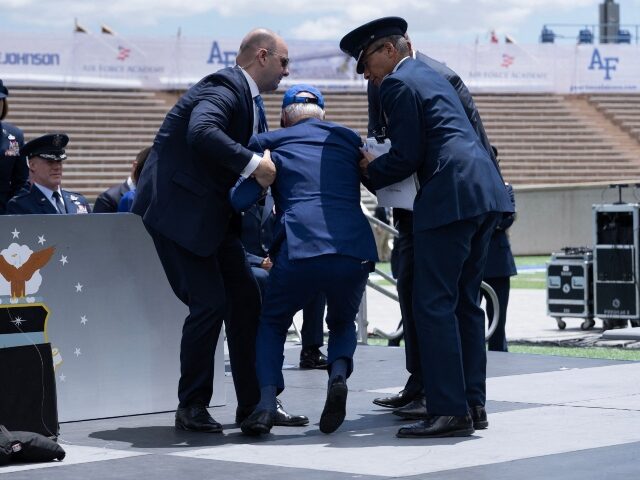 US President Joe Biden is helped up after falling during the graduation ceremony at the Un