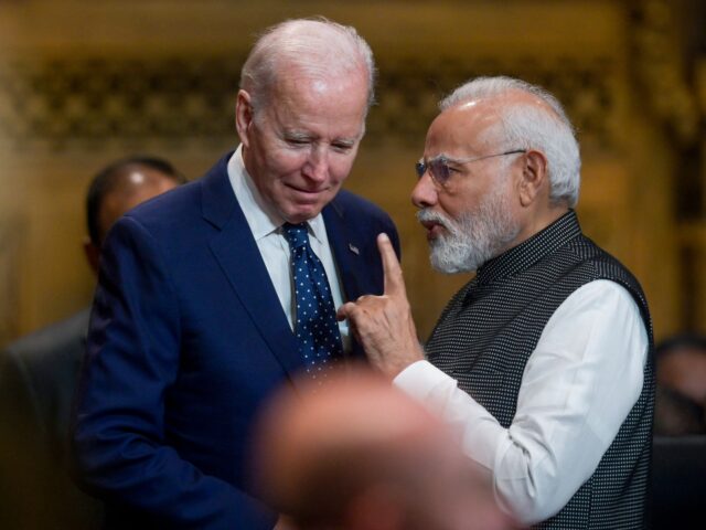 US President Joe Biden (L) talks with India's Prime Minister Narendra Modi at the opening