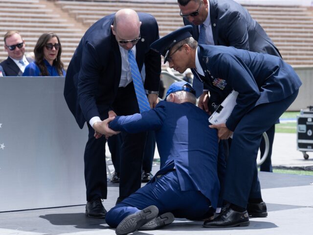TOPSHOT - US President Joe Biden is helped up after falling during the graduation ceremony at the United States Air Force Academy, just north of Colorado Springs in El Paso County, Colorado, on June 1, 2023. (Photo by Brendan Smialowski / AFP) (Photo by BRENDAN SMIALOWSKI/AFP via Getty Images)