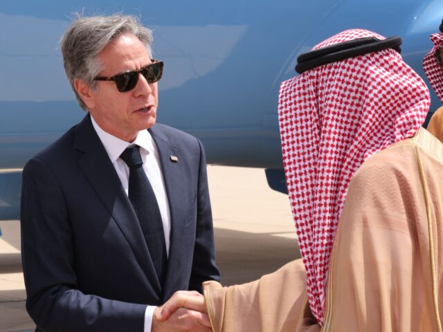 US Secretary of State Antony Blinken is greeted by a Saudi official upon his arrival at th