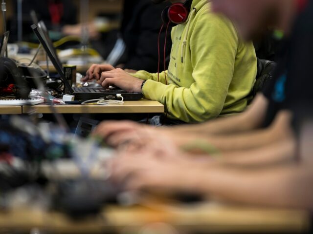 TOKYO, JAPAN - FEBRUARY 18: Participants use laptop computers as they take part in the SEC