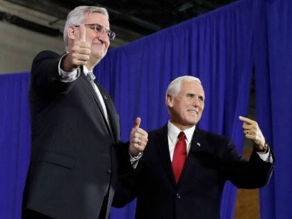 Vice President Mike Pence is introduced by Indiana Gov. Eric Holcomb at the Wylam Center of Flagship East, Friday, Sept. 22, 2017, in Anderson, Ind. (AP Photo/Darron Cummings)