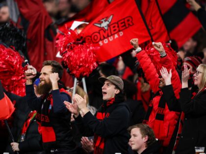 MELBOURNE, AUSTRALIA - JUNE 11: Essendon fans celebrate a goal during the 2023 AFL Round 13 match between the Carlton Blues and the Essendon Bombers at the Melbourne Cricket Ground on June 11, 2023 in Melbourne, Australia. (Photo by Dylan Burns/AFL Photos via Getty Images)