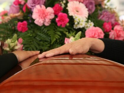 funeral-casket-hands-flowers
