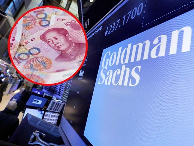In this Dec. 13, 2016, file photo, the logo for Goldman Sachs appears above a trading post