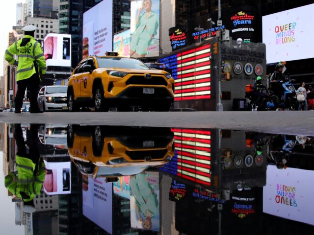 A traffic officer directs cars near Times Square in New York City on June 16, 2023. (Photo