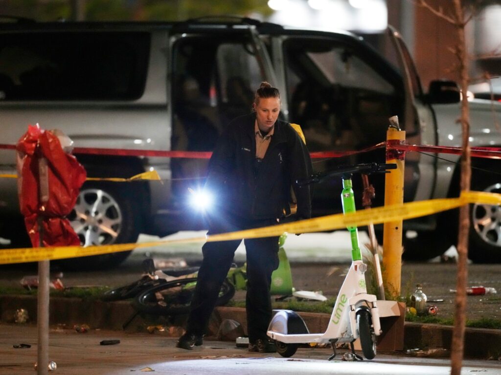 Denver Police Department investigators work the scene of a mass shooting early Tuesday, June 13, 2023, in Denver. Police say several people were wounded in an area where basketball fans had been celebrating the Denver Nuggets first NBA title win. A man who is a suspect was one of the people shot and was taken into custody.(AP Photo/David Zalubowski)