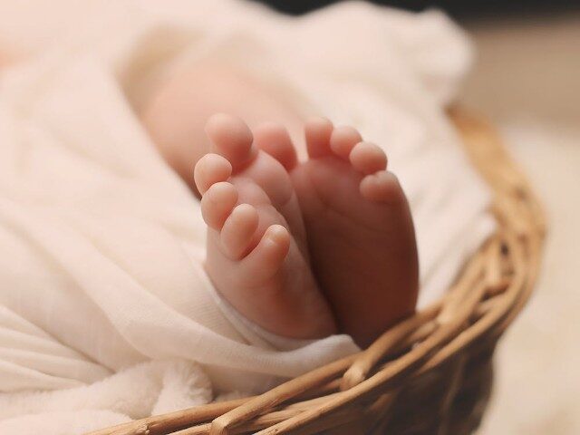 Baby's Feet on Brown Wicker Basket