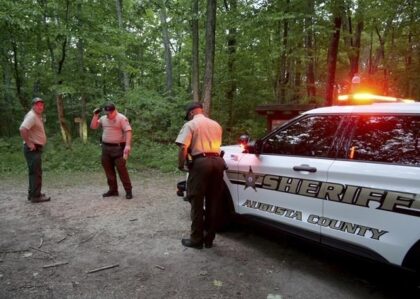 Authorities secure the entrance to Mine Bank Trail, an access point to the rescue operation along the Blue Ridge Parkway where a Cessna Citation crashed over mountainous terrain near Montebello, Va., Sunday, June 4, 2023. (Randall K. Wolf via AP)