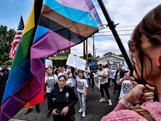 Protesters shout out slogans and carry signs as police officers separate them from counter-protesters at the Saticoy Elementary School in the North Hollywood section of Los Angeles, Friday, June 2, 2023. Los Angeles elementary school has become a flashpoint for Pride Month events and activities across California. (AP Photo/Richard Vogel)