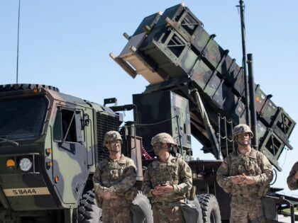 FILE - Members of US 10th Army Air and Missile Defense Command stands next to a Patriot su