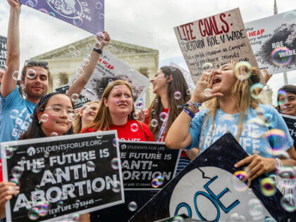 WASHINGTON, DC - JUNE 24: Anti-abortion activists celebrate in response to the Dobbs v Jackson Women's Health Organization ruling in front of the U.S. Supreme Court on June 24, 2022 in Washington, DC. The Court's decision in Dobbs v Jackson Women's Health overturns the landmark 50-year-old Roe v Wade case …