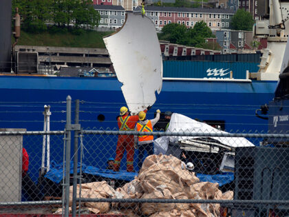 Debris from the Titan submersible, recovered from the ocean floor near the wreck of the Titanic, is unloaded from the ship Horizon Arctic at the Canadian Coast Guard pier in St. John's, Newfoundland on June 28, 2023. (Paul Daly/The Canadian Press via AP)