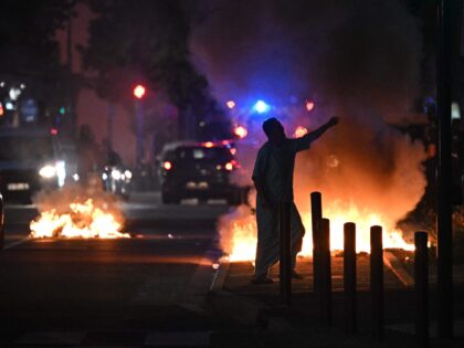 OPSHOT - A man walks past a bonfire in a residential area during clashes in Toulouse, sout