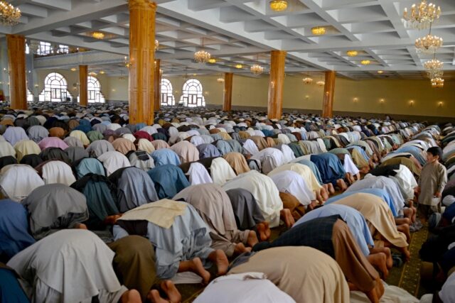 Afghan men pray at a mosque on the first day of Eid al-Adha in Shahidan Square, Kandahar