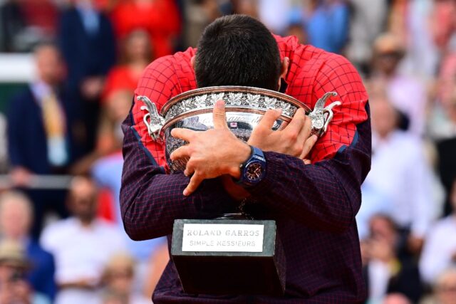 Champion: Novak Djokovic hugs his trophy