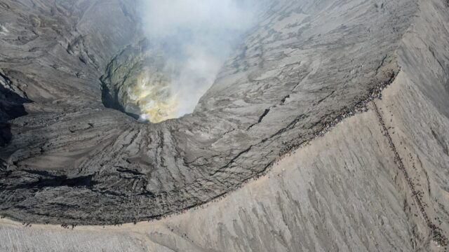 Devotees swarm the thin rim around the basin of Mount Bromo