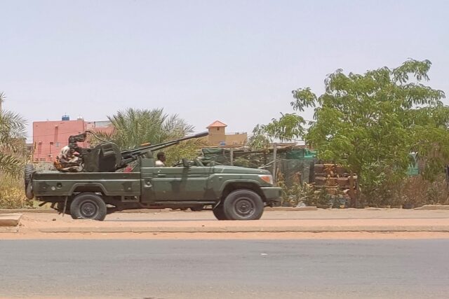 Fighters of the paramilitary Rapid Support Forces (RSF) drive an armoured vehicle in south