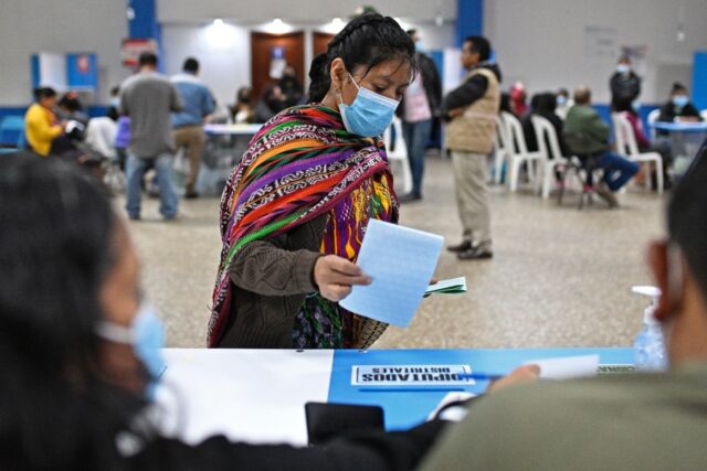 A Guatemalan woman casts her ballot at a voting station in San Juan Sacatepequez, west of