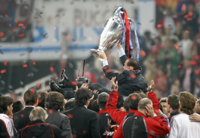 Silvio Berlusconi celebrates with the Champions League trophy after AC Milan beat Liverpoo