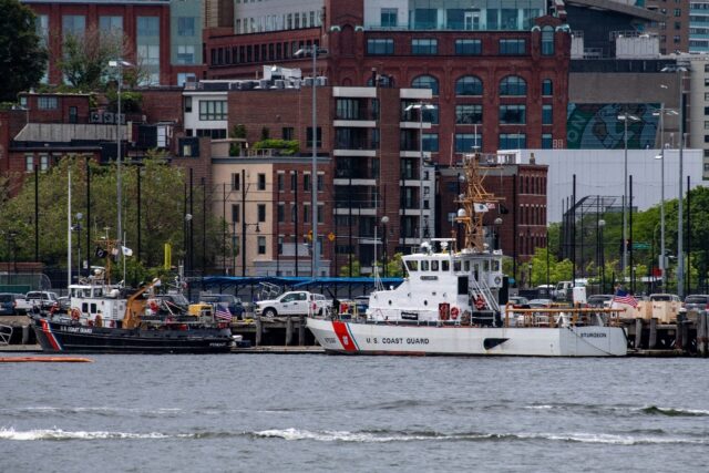 Two US Coast Guard vessels sit in port in Boston Harbor, from where authorities are mounti