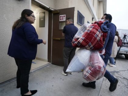 Official bring new blankets into St. Anthony's Croatian Catholic Church in Los Angeles on Wednesday, June 14, 2023. Forty-two migrants, including some children, were dropped off at Union Station around 4 p.m. Wednesday and were being cared for at the church. Texas Gov. Greg Abbott said the migrants were sent …