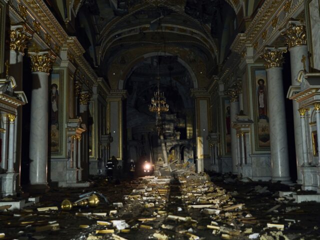 Firefighters walk inside the Odesa Transfiguration Cathedral, heavily damaged in a Russian