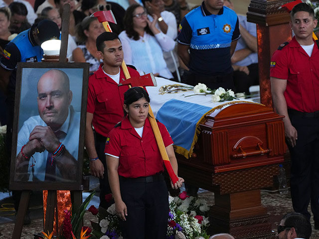 Firemen guard the coffin during the funeral of the Mayor of Manta, Agustin Intriago, who w