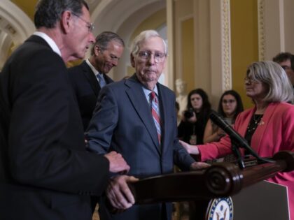 Senate Minority Leader Mitch McConnell, R-Ky., center, is helped by, from left, Sen. John Barrasso, R-Wyo., Sen. John Thune, R-S.D., and Sen. Joni Ernst, R-Iowa, after the 81-year-old GOP leader froze at the microphones as he arrived for a news conference, at the Capitol in Washington, Wednesday, July 26, 2023. …