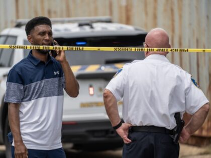Baltimore Mayor Brandon Scott speaks on the phone at the site of a shooting in the Brooklyn Homes neighborhood on July 2, 2023 in Baltimore, Maryland. At least two people were killed and 28 others were wounded during the shooting at a block party on Saturday night. (Nathan Howard/Getty Images)
