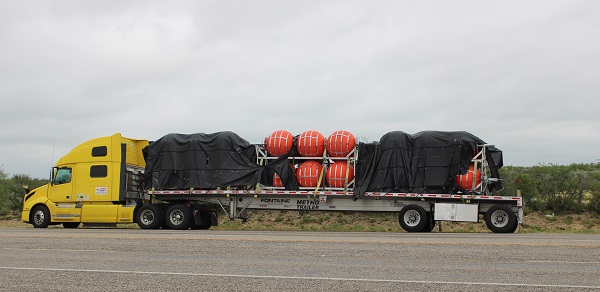 A tractor-trailers stands by to deliver Governor Greg Abbott's border buoy floating border barrier system. (Randy Clark/Breitbart Texas)