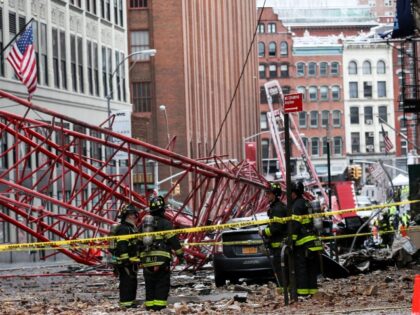 NEW YORK, USA - FEBRUARY 5: Fire brigade crew work at the scene of a collapsed crane on a roadway in lower Manhattan of New York, USA on February 5, 2016. A large construction crane has collapsed in lower Manhattan in New York City, killing one person and injuring at …