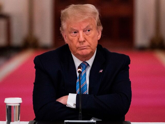 TOPSHOT - US President Donald Trump sits with his arms crossed during a roundtable discussion on the Safe Reopening of Americas Schools during the coronavirus pandemic, in the East Room of the White House on July 7, 2020, in Washington, DC. (Photo by JIM WATSON / AFP) (Photo by JIM …