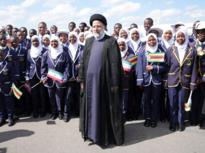 Iran's President Ebrahim Raisi poses for a photograph with children upon his arrival at Ro