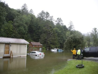 People check on a flooded home in Bridgewater, Vt., on Monday, July 10, 2023. Heavy rain drenched part of the Northeast, washing out roads, forcing evacuations and halting some airline travel. (Hasan Jamali/AP)