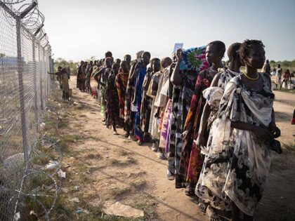 Women from Murle ethnic group wait in a line for a food distribution by United Nations World Food Programme (WFP) in Gumuruk, South Sudan, on June 10, 2021, as their village where recently attacked by armed youth group. - An escalation in conflict has led to the displacement of thousands …