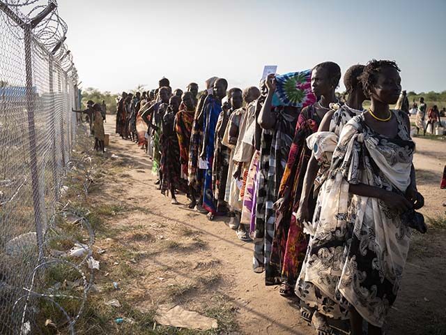 Women from Murle ethnic group wait in a line for a food distribution by United Nations Wor