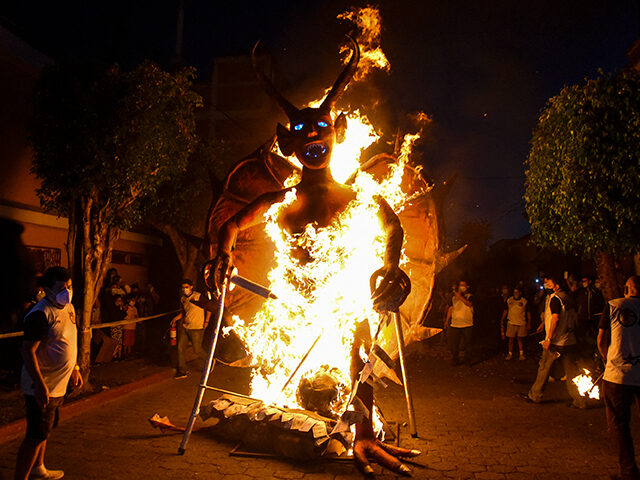 A figure representing the devil burns during the celebration of the Virgin of the Immacula