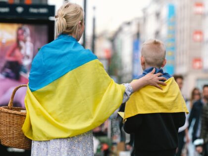 a group of Ukraine refugees hand out some flowers and Thank you cards on the street of Duesseldorf, Germany on April 14, 2022 as part of appreication toward the German public supporting and hosting Ukrain refugees.during the war time. (Photo by Ying Tang/NurPhoto via Getty Images)