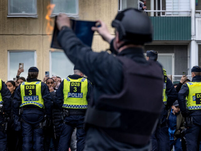 STOCKHOLM, SWEDEN - MAY 14: Rasmus Paludan burns a Koran during an election meeting in Hus