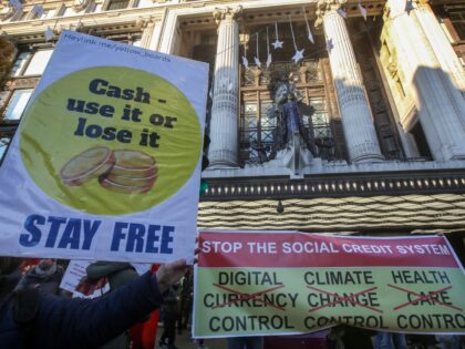 LONDON, UNITED KINGDOM - 2000/01/01: A protester holds a placard saying Cash - use it or l