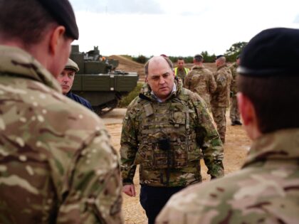 Britain's Defence Secretary Ben Wallace speaks to the crew of an Ajax Ares Armoured Fighting Vehicle, on the training range at Bovington Camp, a British Army military base, while viewing Ukrainian soldiers undergoing training, southwest England, on February 22, 2023. (Photo by Ben Birchall / POOL / AFP) (Photo by …